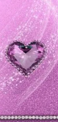 This mobile wallpaper shows a heart design on a cellphone, surrounded by purple hues and pink diamond detailing