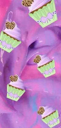 This phone live wallpaper showcases colorful cupcakes with sprinkles on a lilac background