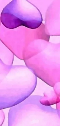 This live wallpaper features two hearts sitting on a pile of rocks, surrounded by soft cotton candy clouds
