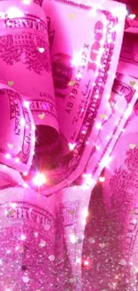 This live wallpaper features a vibrant digital art piece with bright pink and purple lights surrounding stacks of cash sitting on a table