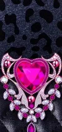 This lively phone live wallpaper features a charming and eye-catching pink heart-shaped brooch that pops dramatically against a sleek black background