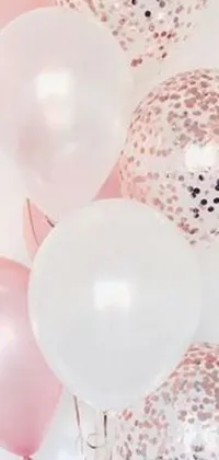 This phone live wallpaper features a delightful scene of colorful balloons floating on top of a table