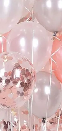 This phone live wallpaper features a bunch of balloons resting on a rose gold sheer table
