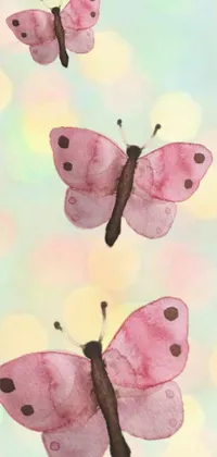 Looking for a stunning phone wallpaper to brighten up your screens? Check out this trending live wallpaper featuring pink butterflies perched on a watercolor painting