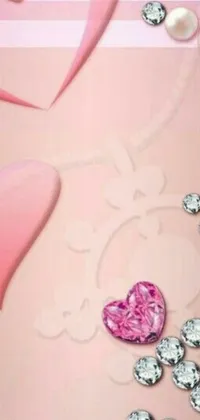 This live wallpaper features a pretty pink heart delicately adorned with beautiful diamonds and pearls, creating a stunning contrast against the solid color background
