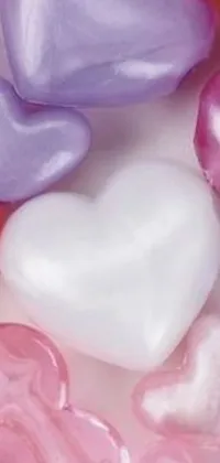 Looking for a romantic and sweet phone live wallpaper? Look no further than this beautiful image of heart-shaped candy resting on a white table