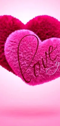 This live phone wallpaper features a pink heart with "love" written in cursive