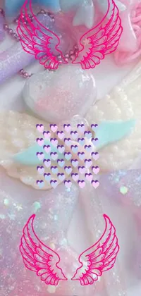This phone live wallpaper displays a exquisitely decorated cake with angel wings on top