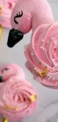 This phone live wallpaper boasts a stunning close-up of pretty pink cupcakes on a stick, surrounded by intricate baroque designs