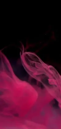This phone live wallpaper features a close-up of pink substance in water, set against a dark, smoky background