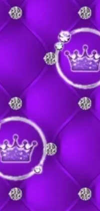 This phone live wallpaper showcases a close-up of a luxurious purple quilt with a gold crown embroidered onto it