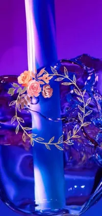 This phone live wallpaper features a beautiful blue candle sitting on a glass vase, with ice-carved patterns on the side