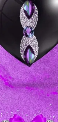 This live phone wallpaper features a black heart with bow on a purple background, complemented by striking tachisme opal statues with elegant jewel accents