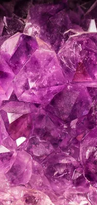 This phone live wallpaper showcases a gleaming pile of purple crystals sitting on a wooden table, designed in crystal cubism style, trending on Pexels