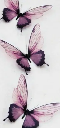 This stunning phone live wallpaper features a group of delicate purple butterflies perched on a white surface