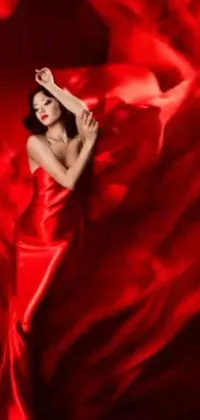 Enjoy the stunning beauty of a woman posing in a red dress for this lively and romantic phone live wallpaper
