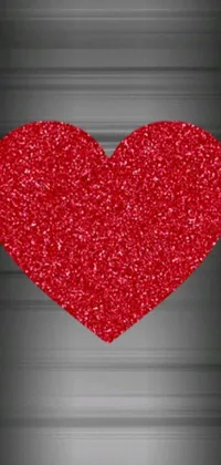 Looking for a stunning new phone live wallpaper? Look no further than this red glitter heart on black background! This iPhone 15 wallpaper features a vibrant red heart, glimmering with shimmering glitter against a black backdrop