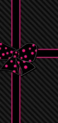 Add a burst of playful charm to your device with this phone live wallpaper featuring a pink bow against a black background