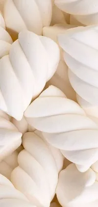 This stunning live wallpaper for phones features a pile of fluffy white icing, complete with a trendy tumblr design, pointy shell, twisted shapes, and light cream and white colors