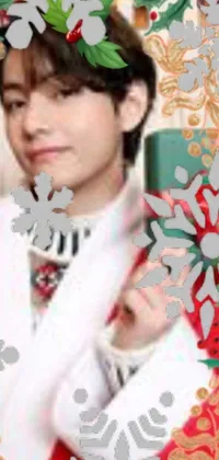 This live phone wallpaper features a close-up of a snowflake held by a person in festive clothing