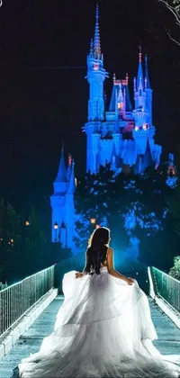 This phone live wallpaper features a stunning bride and a majestic castle standing in a dreamy landscape