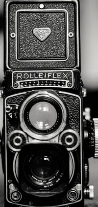 This phone live wallpaper features a striking black and white image of a vintage Rolleiflex reflex camera