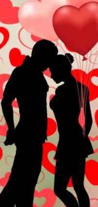 This live phone wallpaper depicts a romantic scene of a couple in silhouette sharing a kiss in front of dynamic hearts