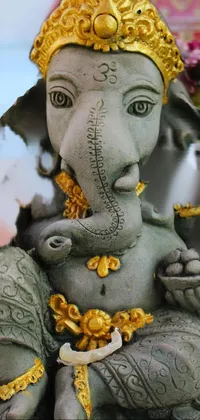 This phone live wallpaper showcases a stunning close-up of a cement and concrete statue of an elephant, known as Ganesha in pagan religion