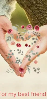 This phone live wallpaper showcases a digital rendering of a heart shape being made with hands set against a backdrop of pressed flowers, creating an overall vibe of romance