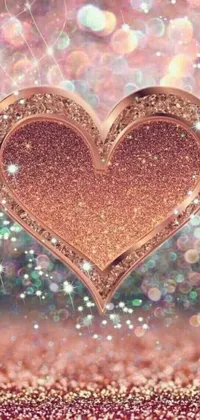 This phone live wallpaper features a close up of a heart on a glitter background with a rose gold hue