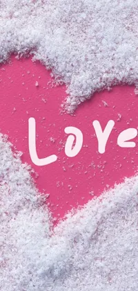 This phone live wallpaper features a charming heart design in the snow, with the word "love" written in elegant script