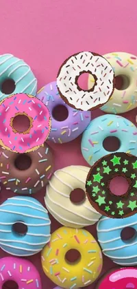 This lively phone live wallpaper features a colorful pile of donuts on top of a pink background