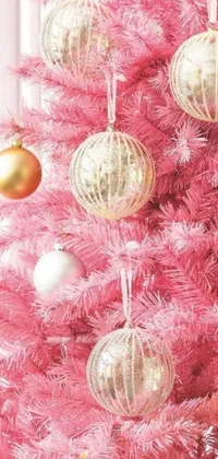 This phone live wallpaper features a gorgeous pink Christmas tree decorated with ornaments of gold and silver
