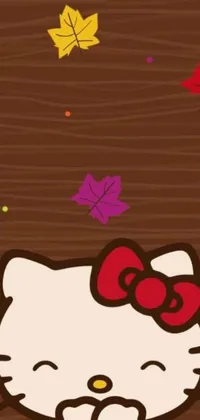 This phone live wallpaper features a cute Hello Kitty character sitting on a wooden table against a brown background with autumn leaves