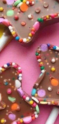 Indulge in sweet cravings with a mesmerizing mobile wallpaper featuring up-close chocolate lollipops with colorful sprinkles