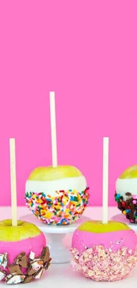 This lively phone live wallpaper features a colorful pattern of candy apples with sprinkles on them