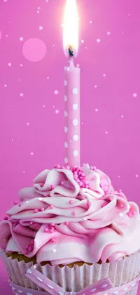 This phone live wallpaper features a high poly rendering of a cupcake with a lit candle on top, set against a pink background