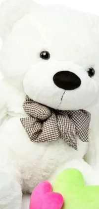Looking for a cute and adorable live wallpaper for your phone? Check out this lovely white teddy bear with a bow tie and a heart by Toyen