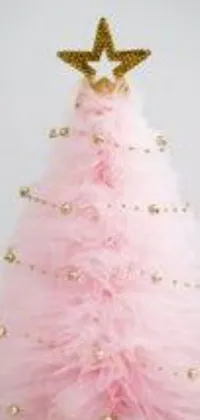 This charming live phone wallpaper boasts a pink Christmas tree accented by gold ornaments and a shining star topper, adding a luxurious feel to its Tumblr-inspired pastel color scheme