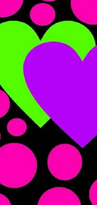 This live wallpaper features two animated hearts in shades of purple and green set against a black background
