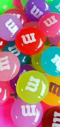 Deck out your phone with a vibrant and eye-catching wallpaper featuring a heap of M&M's