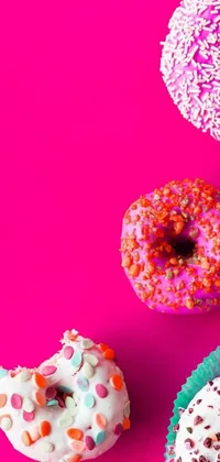 Decorate your phone with this vibrant live wallpaper of doughnuts with sprinkles! The pop art design by Anna Haifisch features colorful treats on a pink background