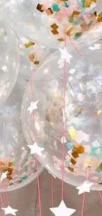 This live wallpaper features clear balloons filled with confetti, creating a playful and cheerful atmosphere on your phone screen
