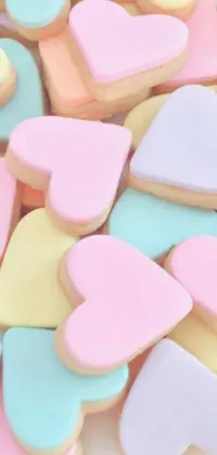 This pastel phone live wallpaper exudes a delightful and whimsical atmosphere with a pile of heart-shaped cookies on a wooden table