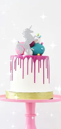 This phone live wallpaper features a pastel cake sitting on a pink plate, accompanied by a white unicorn dipped in tar, creating a dazzling silver tone