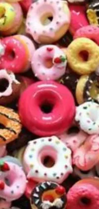Satisfy your sweet craving with this live wallpaper featuring a close-up view of a pile of assorted donuts with colorful sprinkles