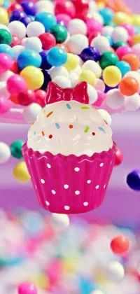 This colorful and playful phone live wallpaper features a close up of a delicious cupcake with sprinkles
