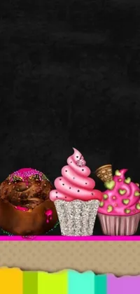 This dynamic phone live wallpaper features a group of vividly colored cupcakes resting on a smooth black table