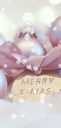 This live wallpaper for your phone showcases a cute and festive display of ornaments and snow, adding a whimsical touch to your device