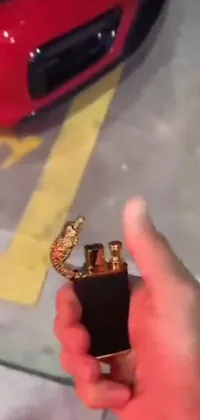 This phone live wallpaper showcases a stunning scene of a person holding a lighter in their hand in a parking lot in Mexico, with golden snakes surrounding them